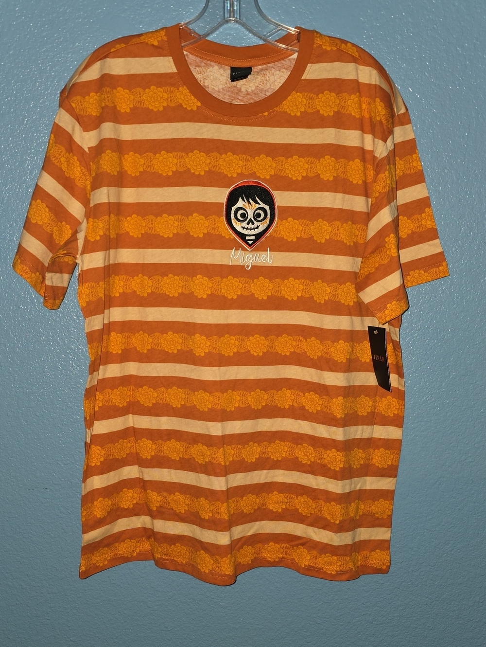 Hot Topic Orange and Cream Striped Miguel Graphic Tee